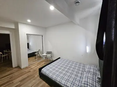 a bedroom with a bed and a table and chairs at Private room in Basement suite in Edmonton