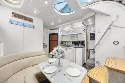 a dining room and kitchen in a rv at COSY FLOATING HOME IN Vancouver downtown in Vancouver