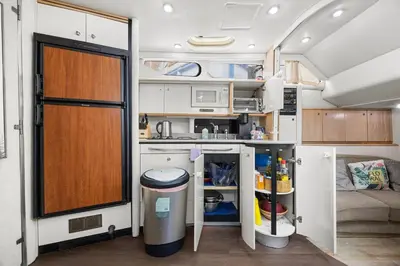 a kitchen in an rv with a refrigerator at COSY FLOATING HOME IN Vancouver downtown in Vancouver