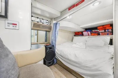 a small bedroom with a bed in a rv at COSY FLOATING HOME IN Vancouver downtown in Vancouver