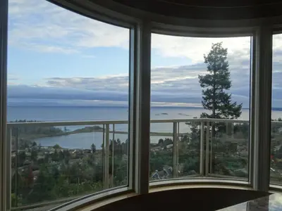 a room with a large window looking out at the water at Gibralter Rock Ocean View B&B in Nanaimo
