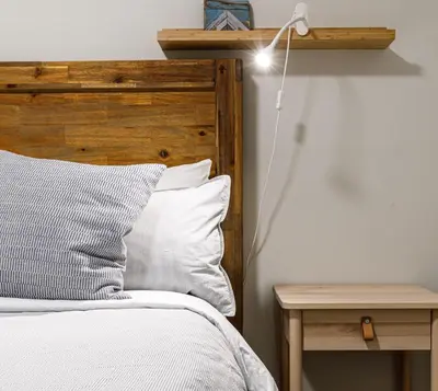 a bedroom with a bed and a lamp on a table at El Refugio - Private Townhouse with Amazing Views in Canmore