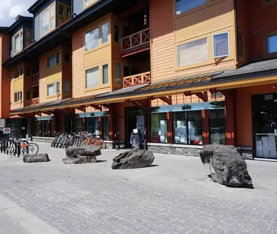 a building with rocks in the middle of a street at Alpen Glow at Canmore Crossing in Canmore