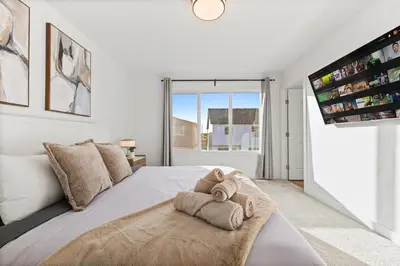 a bedroom with a large bed with towels on it at Luxe Retreat with Gym, Ping Pong, King Bed, Near WEM in Edmonton