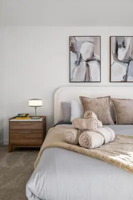 a bedroom with a bed with towels on it at Luxe Retreat with Gym, Ping Pong, King Bed, Near WEM in Edmonton