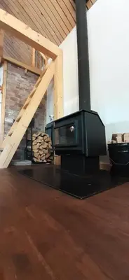 a room with a fireplace and a tv on a floor at Yukon Sweet Spot Bed and Bakery in Whitehorse