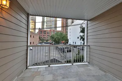 a room with a balcony with a view of a city at Ice District 2 Kings Private Parking Patio in Edmonton