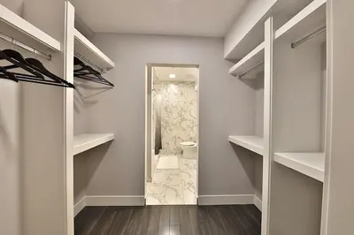 a bathroom with a walk in closet with a mirror at Ice District 2 Kings Private Parking Patio in Edmonton