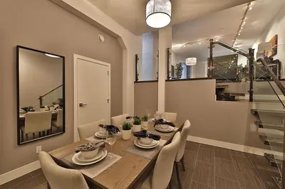 a dining room with a wooden table and chairs at Ice District 2 Kings Private Parking Patio in Edmonton