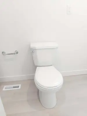 a bathroom with a white toilet in a room at 43 Erin Woods Drive SE Calgary in Calgary