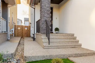 a house with a staircase leading to the front door at Cozy, Classy 2 BedRM Private Suite with Netflix and Parking in Edmonton