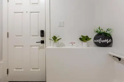 a white door with plants sitting on a counter at Cozy, Classy 2 BedRM Private Suite with Netflix and Parking in Edmonton