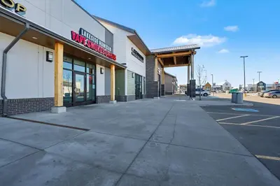an empty sidewalk in front of a store at Deluxe Mahogany Lake Getaway Sleeps 4 in Calgary
