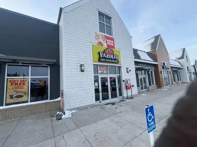 an empty street with a croissant shop on the corner at Deluxe 2-Bedroom Getaway Near Mahogany Lake in Calgary