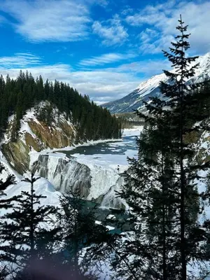 a river with snow on the side of a mountain at Golden Moments in Golden