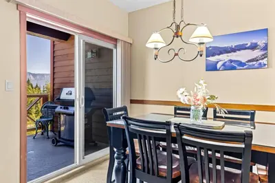 a dining room with a table and chairs and a desk at Whispering Pines 3BR Townhouse Views and private Hot Tub in Golden