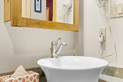 a white sink in a bathroom with a mirror at Whispering Pines 3BR Townhouse Views and private Hot Tub in Golden