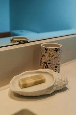 a banana on a plate next to a cup at Chesterman on the Point - Beachfront in Tofino