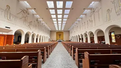 a row of pews in a church with a aisle at Sunny 1BR Detached Suite - Near City Center in Vancouver