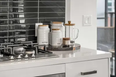 a kitchen with a counter with jars on it at The Domain Skyline View King Beds Pool Gym in Calgary