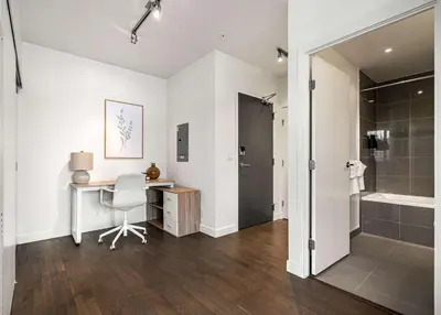 a white bathroom with a desk and a shower at The Domain Skyline View King Beds Pool Gym in Calgary