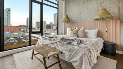 a bedroom with a large bed and a large window at The Domain Skyline View King Beds Pool Gym in Calgary