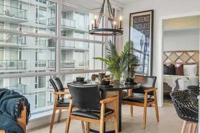 a dining room with a table and chairs at Manhattan Right Next to Stampede Grounds DT in Calgary