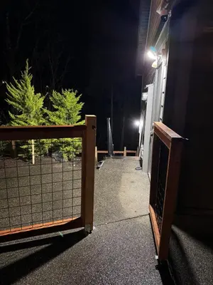 an open gate to a house at night at Lovely 2 bedroom suite in Langford in Metchosin