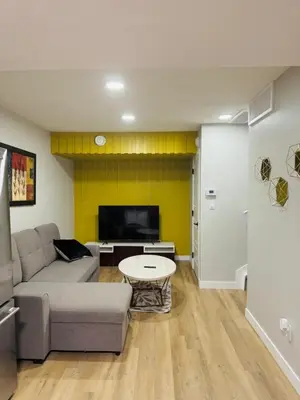 a living room with a couch and a table at Roj exclusive comfort home in Edmonton