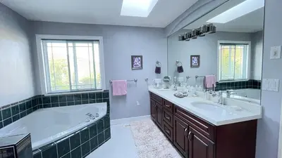 a bathroom with a large tub and a sink at Warm house1 in Coquitlam