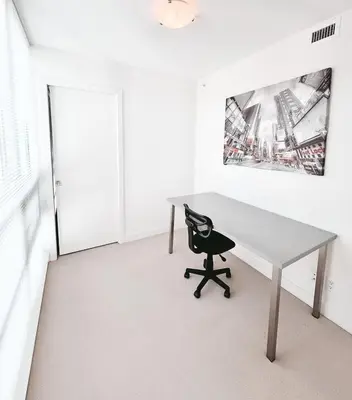 a desk and a chair in a room at Riverside Mint 2bd den 2 ba in Calgary