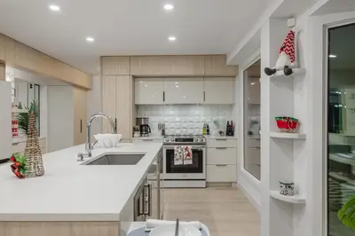 a kitchen with a sink and a stove top oven at Board Games, King Bed, Cocoa Bar, & Firewood! in Calgary
