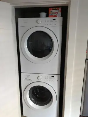 a white washer and dryer in a room at 2 bed Suburban Oasis in Surrey in Surrey