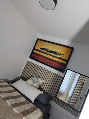 a bedroom with a bed and a painting on the wall at The Loft Modern in Calgary