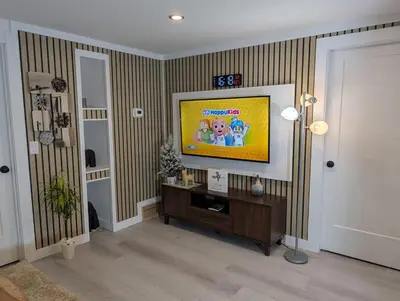 a living room with a flat screen tv on a wall at The Loft Modern in Calgary