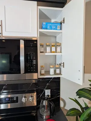 a kitchen with a microwave and a stove at The Loft Modern in Calgary