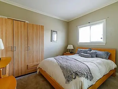a bedroom with a large bed and a window at 5 Minutes away from Edmonds Station! Ideal location for all events & attractions in New Westminster