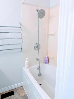 a white bath tub in a bathroom with a window at Executive Suite 2 Bedroom Serviced Apartment in Alert Bay
