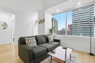 a living room with a couch and a large window at Luxury 1Beds and 2Beds in Downtown Edmonton close to Rogers in Edmonton