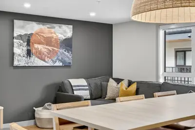 a living room with a couch and a table at Downtown Revelstoke Retreat by Canadian Rockies Vacation Rentals in Revelstoke