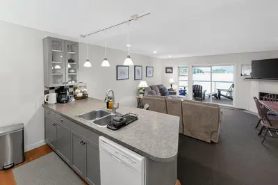 a kitchen and living room with a counter top at The Landing- Your Downtown Waterfront Oasis in Tofino