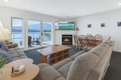 a living room with a couch and a table at The Landing- Your Downtown Waterfront Oasis in Tofino