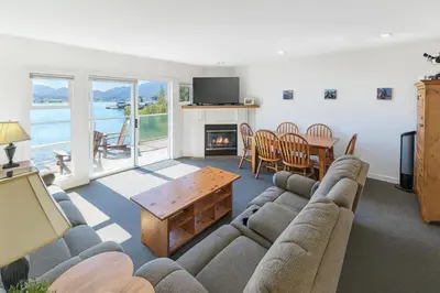 a living room with a couch and a table at The Landing- Your Downtown Waterfront Oasis in Tofino