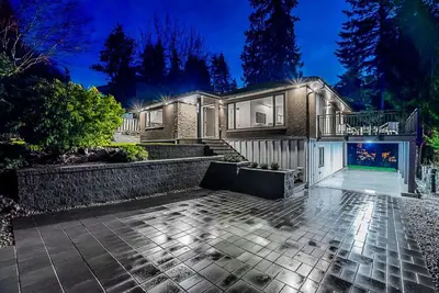 a brick house with a fireplace in front of it at Family Home in North Vancouver