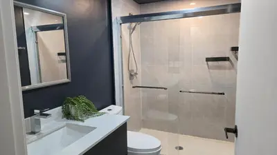 a bathroom with a shower and a sink and a toilet at Family Home in North Vancouver