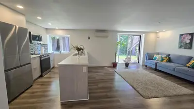 a kitchen and living room with a blue couch at Family Home in North Vancouver