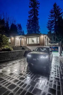 a car parked in front of a house at night at Family Home in North Vancouver