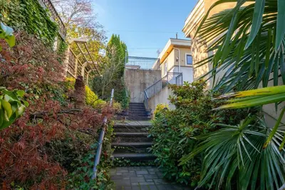 a set of stairs leading up to a building at New Quiet Charming 1BR Suite near UBC & PW Park in Vancouver