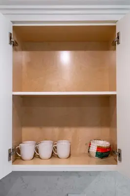 a cupboard with three cups in it at New Quiet Charming 1BR Suite near UBC & PW Park in Vancouver