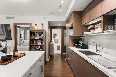 a large kitchen with a sink and a counter at Modern Chic Apartment with Balcony & Workspace in Vancouver